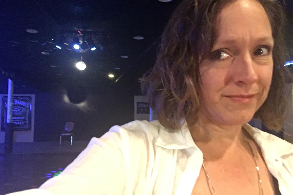 Selfie view of the open mic tourist and an empty chair on the stage at Dexter, ME