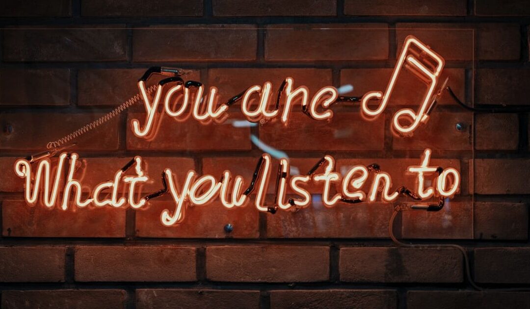 neon sign reading "you are what you listen to"
