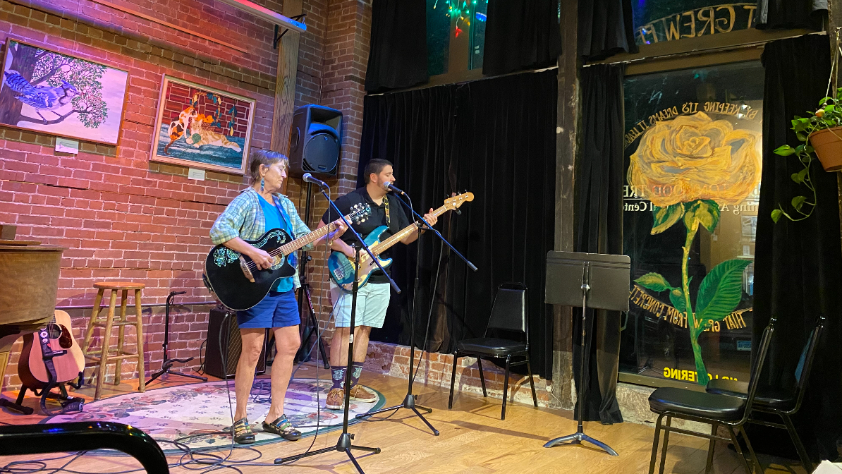 Two guitar players on stage at The Buttonwood Tree for the closing jam