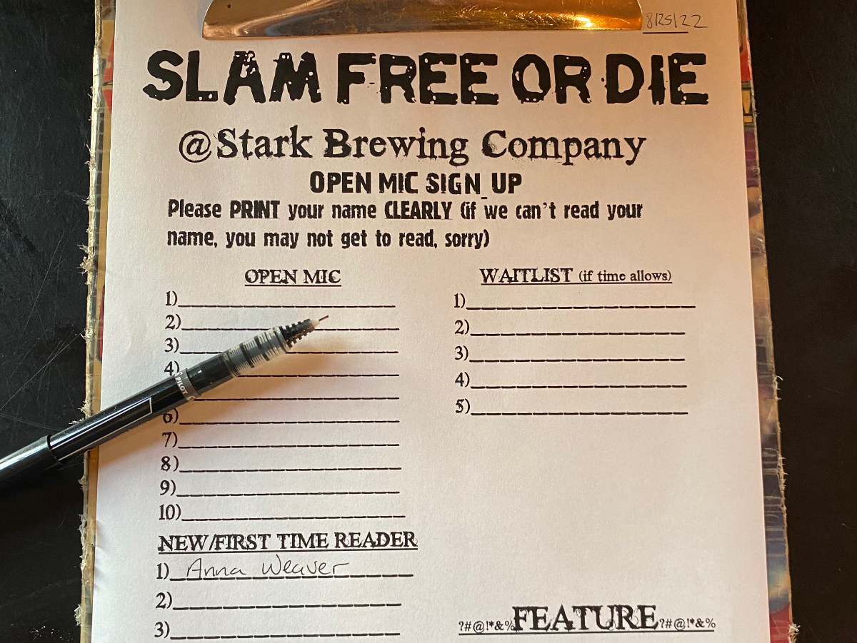 Clipboard with the signup list for the Slam Free or Die open mic